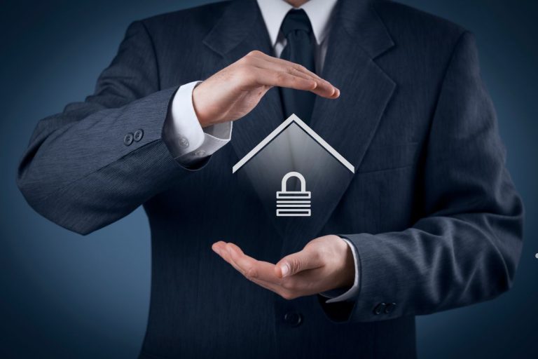 Businessman holding a house icon secured with a padlock and key, symbolizing home security mistakes.